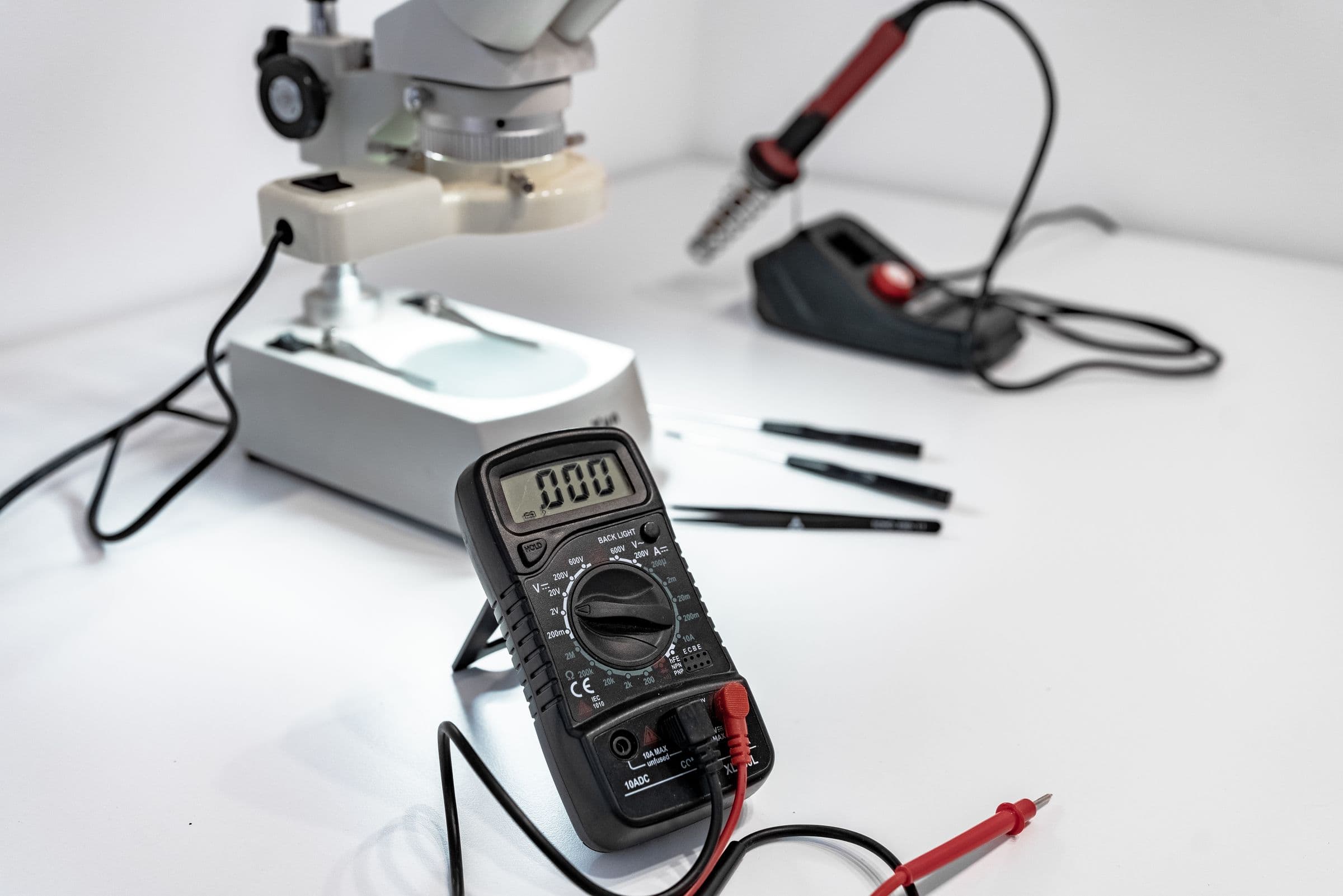 Service bench with a stereo microscope, multimeter and hand tools